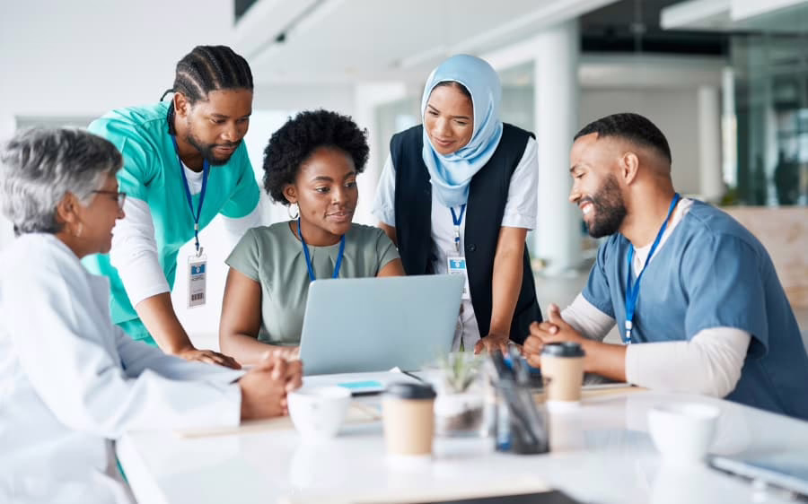 Health workers reviewing records together in a healthcare facility
